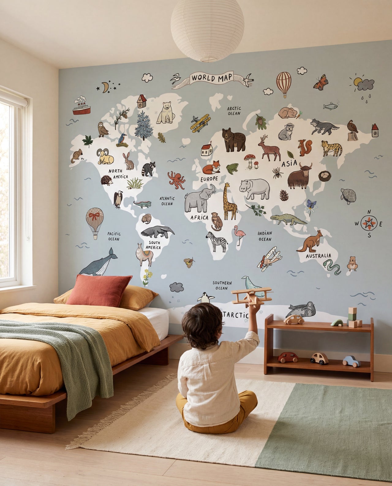 Papier peint enfant Les Explorateurs, enfant qui observe la mappemonde illustrée du mur, Wonderwall Casablanca